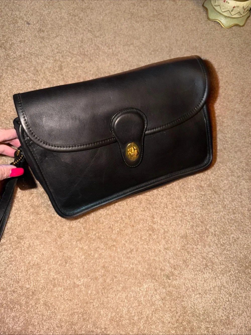 NWOT vintage black leather Coach wristlet features a classic a detachable strap